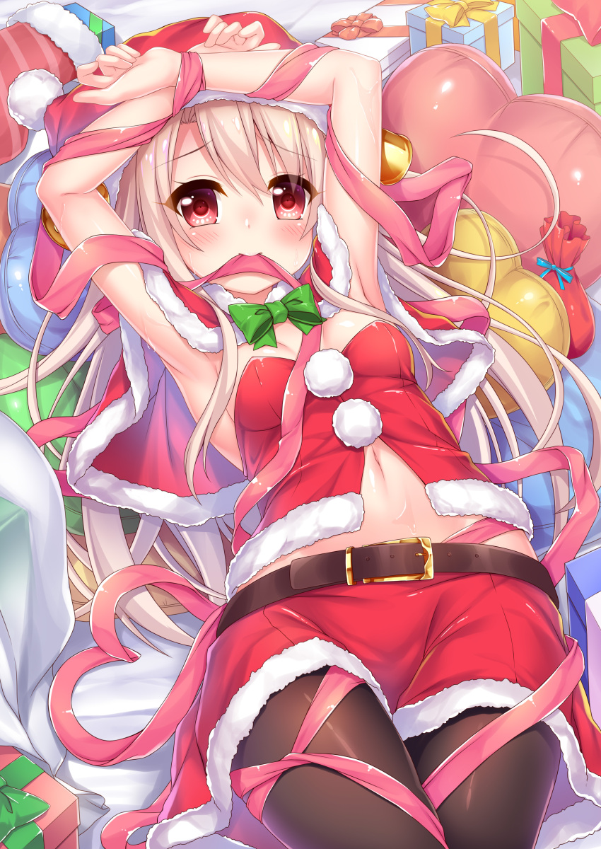 1girl absurdres armpits bangs bed_sheet bell belt_buckle black_belt black_legwear blush bow bowtie box breasts buckle commentary_request eyebrows_visible_through_hair fate/kaleid_liner_prisma_illya fate_(series) fur-trimmed_capelet fur-trimmed_hat fur-trimmed_skirt gift gift_box green_neckwear hair_between_eyes hat heart heart_pillow highres illyasviel_von_einzbern light_brown_hair looking_at_viewer lying mouth_hold navel on_back pantyhose pillow pink_ribbon red_capelet red_eyes red_hat red_skirt ribbon ribbon_in_mouth santa_costume santa_hat skirt small_breasts solo wakagi_repa