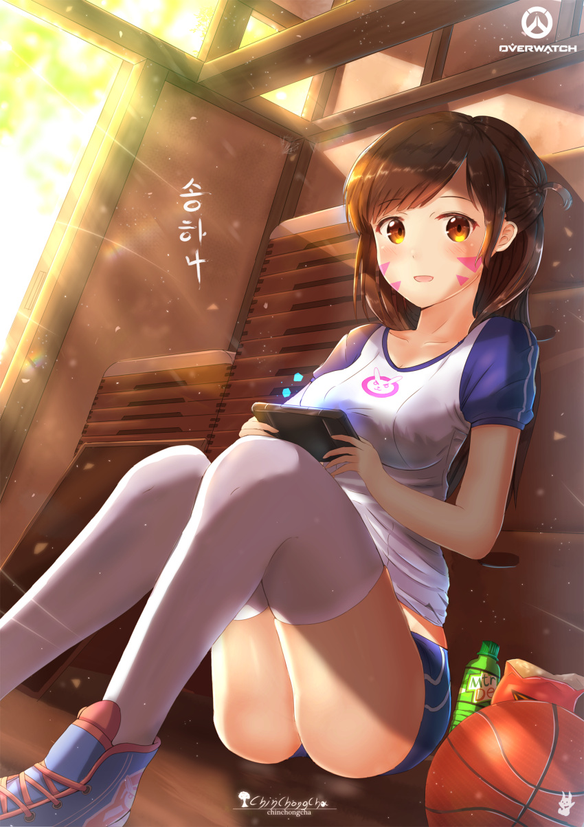 1girl bangs brown_eyes brown_hair chinchongcha collarbone d.va_(overwatch) day facepaint facial_mark gym_storeroom handheld_game_console highres indoors long_hair looking_at_viewer open_mouth overwatch shorts sitting swept_bangs thigh-highs whisker_markings