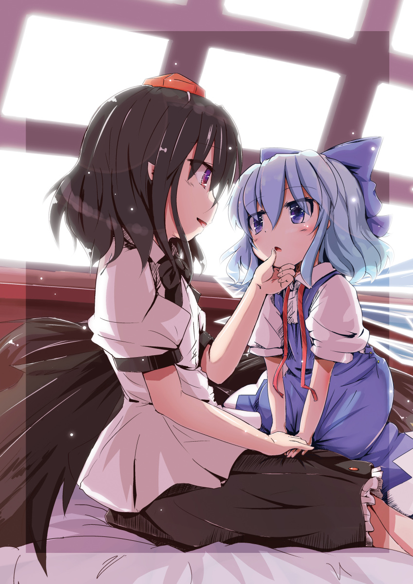 2girls absurdres black_hair black_neckwear black_skirt black_wings blue_bow blue_dress blue_eyes blue_hair bow bowtie dress eye_contact feathered_wings hair_bow hand_on_another's_chin hat highres ice ice_wings indoors infrontie looking_at_another miniskirt multiple_girls pointy_ears puffy_short_sleeves puffy_sleeves red_eyes red_ribbon ribbon shameimaru_aya shirt short_sleeves sitting skirt smile tokin_hat touhou white_shirt wings yuri