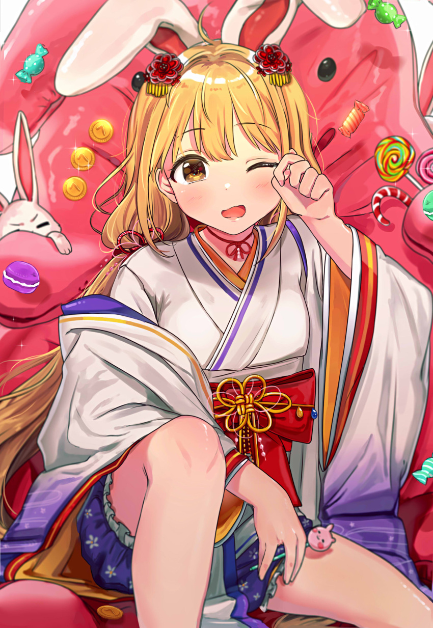 1girl animal_ears blonde_hair blush brown_eyes candy commentary eyebrows_visible_through_hair food frilled_shorts frills futaba_anzu hair_ornament highres idolmaster idolmaster_cinderella_girls idolmaster_cinderella_girls_starlight_stage japanese_clothes kimono long_hair looking_at_viewer low_twintails macaron obi one_eye_closed open_mouth rabbit rabbit_ears rubbing_eyes sash shorts sitting solo stuffed_animal stuffed_bunny stuffed_toy tomato_omurice_melon twintails wide_sleeves yawning