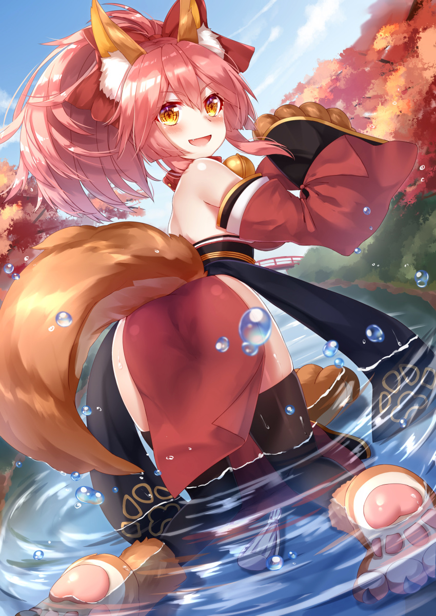 1girl absurdres animal_ears bell bell_collar black_legwear bridge collar detached_sleeves fate/grand_order fate_(series) fox_ears fox_tail from_behind full_body gloves highres japanese_clothes kimono looking_at_viewer looking_back obi outdoors partially_submerged paw_gloves paw_print paw_shoes paws pelvic_curtain pink_hair ponytail red_kimono river sash shoes short_kimono sky sll solo tail tamamo_(fate)_(all) tamamo_cat_(fate) thigh-highs yellow_eyes