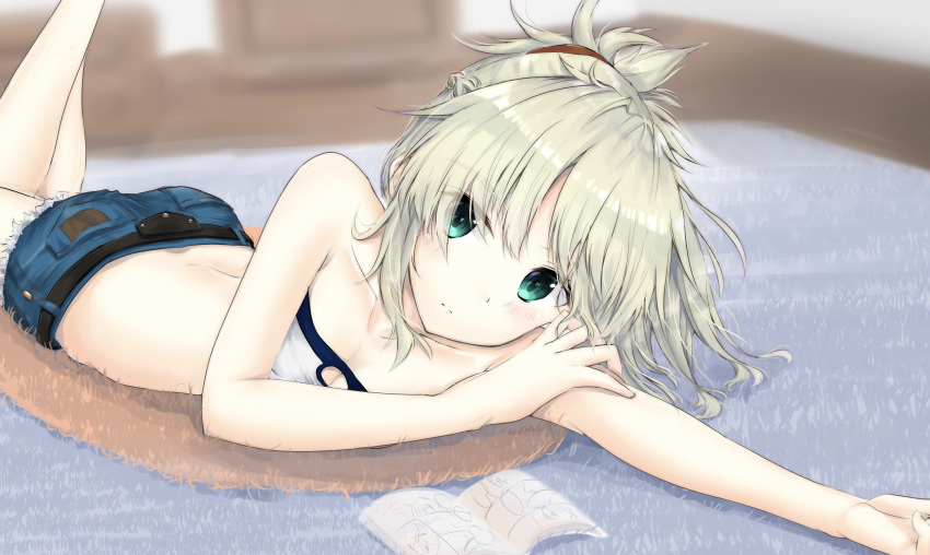 1girl absurdres arm_rest bangs bare_arms bare_shoulders bent_elbow bent_knees blonde_hair blurry blurry_background book breasts closed_mouth collarbone crop_top denim denim_shorts eyebrows_visible_through_hair eyes_visible_through_hair fate_(series) green_eyes hair_ornament hair_over_one_eye highres indoors long_hair looking_at_viewer lying mordred_(fate) mordred_(fate)_(all) on_stomach outstretched_arm ponytail short_shorts shorts simple_background sleeveless small_breasts solo strapless uzuki_tsukuyo