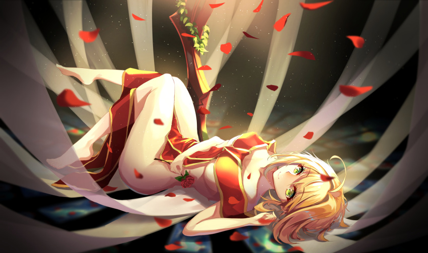 1girl ahoge augu_(523764197) bangs barefoot blonde_hair breasts closed_mouth collarbone dark_background eyebrows_visible_through_hair fate/extra fate_(series) flower from_side full_body green_eyes highres holding holding_flower legs_up light light_particles looking_to_the_side lying medium_breasts motion_blur naked_ribbon nero_claudius_(fate) nero_claudius_(fate)_(all) on_back petals red_flower red_rose ribbon rose rose_petals short_hair smile solo thighs under_boob
