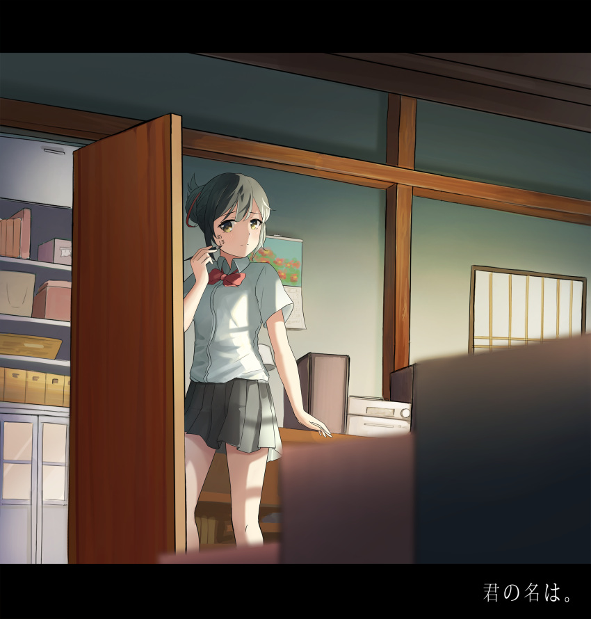 1girl absurdres black_hair black_skirt blush bow box breasts calendar cardboard_box chic_(5666111) closed_mouth copyright_name eyebrows_visible_through_hair hair_ribbon highres holding holding_paintbrush indoors kimi_no_na_wa letterboxed looking_at_viewer medium_breasts miyamizu_mitsuha paintbrush red_bow red_ribbon ribbon shelf short_sleeves skirt solo yellow_eyes