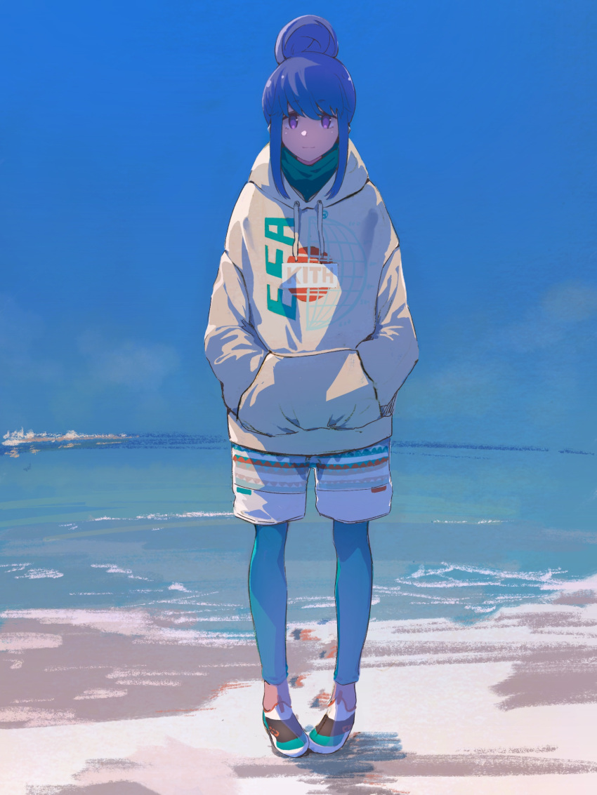 1girl blue_hair blue_sky bonryuu commentary_request hair_bun hands_in_pockets highres hood hoodie long_hair looking_at_viewer ocean outdoors scenery shima_rin shore shorts sky smile solo violet_eyes water yurucamp