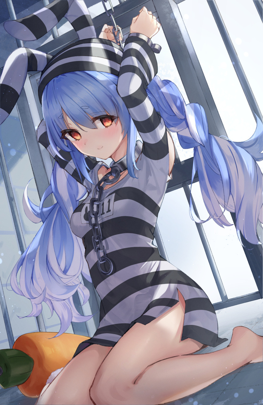 1girl arms_up bangs bare_shoulders barefoot blue_hair blush breasts chain commentary_request cuffs eyebrows_visible_through_hair hat highres hololive indoors kyaroru long_hair long_sleeves looking_at_viewer medium_breasts official_alternate_costume prison prison_clothes red_eyes shirt sitting smile solo striped striped_headwear stuffed_carrot usada_pekora very_long_hair wariza