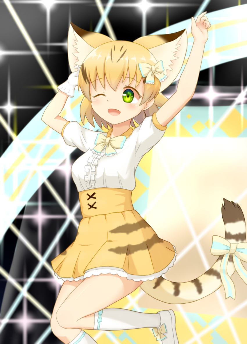 1girl ;d arms_up blonde_hair blurry blurry_background bow cat_tail commentary extra_ears gloves green_eyes highres jumping kemono_friends kneehighs one_eye_closed open_mouth sand_cat_(kemono_friends) sand_cat_print shiraha_maru shoes short_hair short_sleeves single_glove smile solo tail tail_bow white_gloves white_legwear