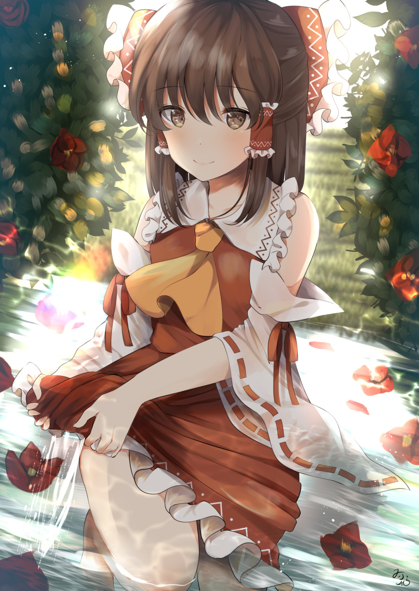 1girl backlighting bangs barefoot blurry blush bow brown_eyes brown_hair bush camellia commentary_request cravat day depth_of_field detached_sleeves eyebrows_visible_through_hair flower frilled_skirt frills grass hair_between_eyes hair_bow hair_tubes hakurei_reimu half_updo highres in_water kneeling looking_at_viewer miri_(miri0xl) outdoors red_skirt red_vest ribbon-trimmed_sleeves ribbon_trim sidelocks signature skirt skirt_set smile solo touhou vest wet wet_clothes wringing_clothes yellow_neckwear