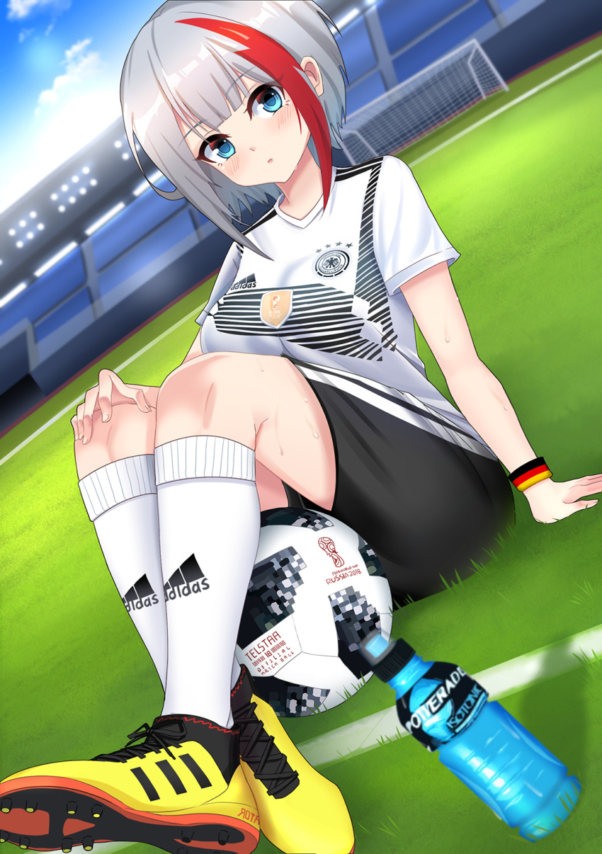 1girl 2018 2018_fifa_world_cup adidas admiral_graf_spee_(azur_lane) arm_support armband azur_lane ball bangs black_shorts blue_eyes blue_sky blush bottle breasts closed_mouth clouds commentary_request day dutch_angle eyebrows_visible_through_hair fingernails german_flag goal grass hand_on_own_knee highres kneehighs large_breasts leng_xiao looking_at_viewer mosaic multicolored_hair on_grass outdoors print_shirt redhead shirt shoes short_hair short_shorts short_sleeves shorts silver_hair sitting sky sneakers soccer soccer_ball soccer_field soccer_uniform solo sportswear stadium streaked_hair sweat sweatband telstar_18 thighs water_bottle white_legwear white_shirt world_cup yellow_footwear