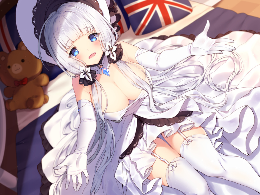 1girl :d absurdres azur_lane bangs bare_shoulders bed blue_eyes blurry blurry_background blush breasts cleavage commentary_request depth_of_field detached_collar dress dutch_angle elbow_gloves eyebrows_visible_through_hair flag_print garter_straps gloves hat highres illustrious_(azur_lane) indoors large_breasts long_hair looking_at_viewer low_twintails on_bed open_mouth outstretched_arms pillow print_pillow silver_hair sitting smile solo strapless strapless_dress stuffed_animal stuffed_toy teddy_bear thigh-highs twintails union_jack usamata very_long_hair white_collar white_dress white_gloves white_hat white_legwear