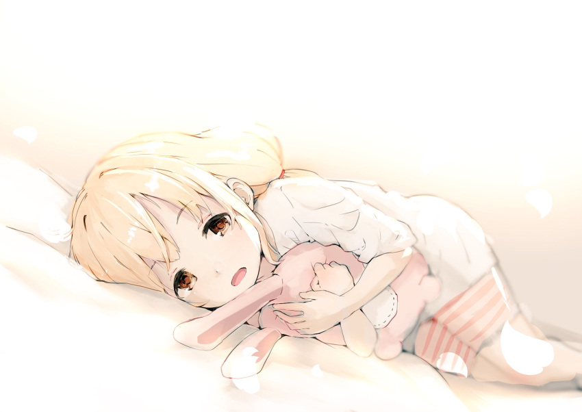1girl backlighting bike_shorts blonde_hair blurry brown_eyes commentary_request depth_of_field eyebrows_visible_through_hair feet_out_of_frame futaba_anzu greatpengh highres holding holding_stuffed_animal idolmaster idolmaster_cinderella_girls long_hair looking_at_viewer low_twintails lying on_side open_mouth shirt solo striped striped_bike_shorts stuffed_animal stuffed_toy t-shirt twintails