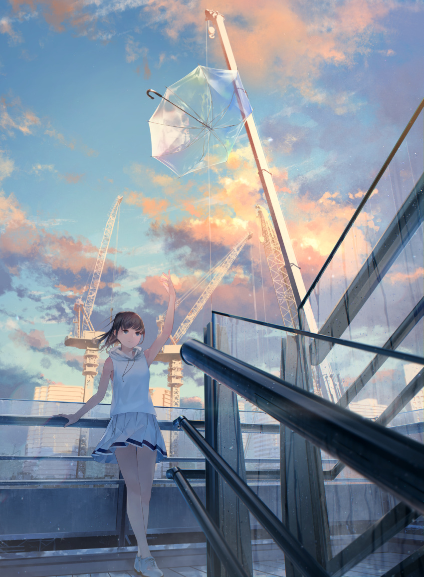 1girl after_rain arm_up bangs blue_eyes blue_sky brown_hair building clouds commentary_request crane day fence highres hood hood_down hoodie looking_at_viewer medium_hair original outdoors pleated_skirt ponytail shoes skirt sky sleeveless sleeveless_hoodie smile sneakers solo sousou_(sousouworks) standing transparent_umbrella umbrella white_footwear white_hoodie white_skirt wind
