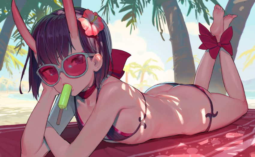 1girl ankle_bow ankle_ribbon ass barefoot bikini black_bikini bow butt_crack fate/grand_order fate_(series) flat_ass flat_chest flower food hair_flower hair_ornament hibiscus horns jpeg_artifacts looking_at_viewer lying mouth_hold on_stomach outdoors popsicle ribbon short_hair shuten_douji_(fate/grand_order) solo string_bikini sunglasses swimsuit the_pose tim_loechner