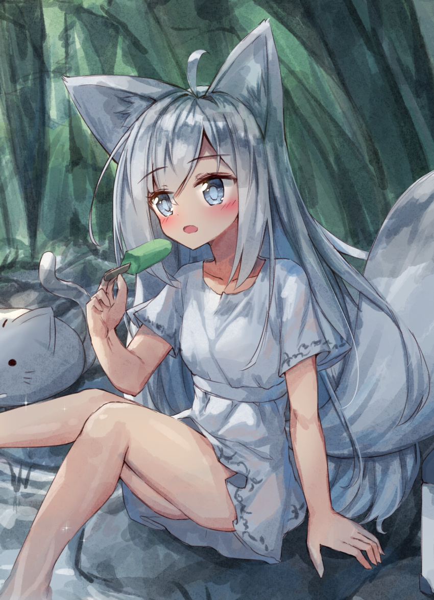 1girl ahoge animal animal_ears arm_support bangs blue_eyes cat collarbone day dress eyebrows_visible_through_hair food forest fox_ears fox_girl fox_tail hair_between_eyes hand_up highres holding holding_food long_hair nature open_mouth original outdoors popsicle rock short_sleeves silver_hair sitting solo sparkle tail tandohark very_long_hair white_dress