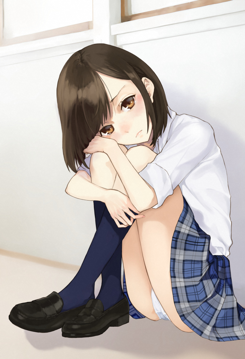 1girl ashiya_hiro black_footwear blue_skirt blush brown_eyes brown_hair closed_mouth commentary fingernails highres indoors kneehighs leg_hug loafers looking_at_viewer navy_blue_legwear on_floor original panties plaid plaid_skirt pleated_skirt school_uniform shirt shoes short_sleeves sitting skirt solo symbol_commentary tears underwear white_panties white_shirt