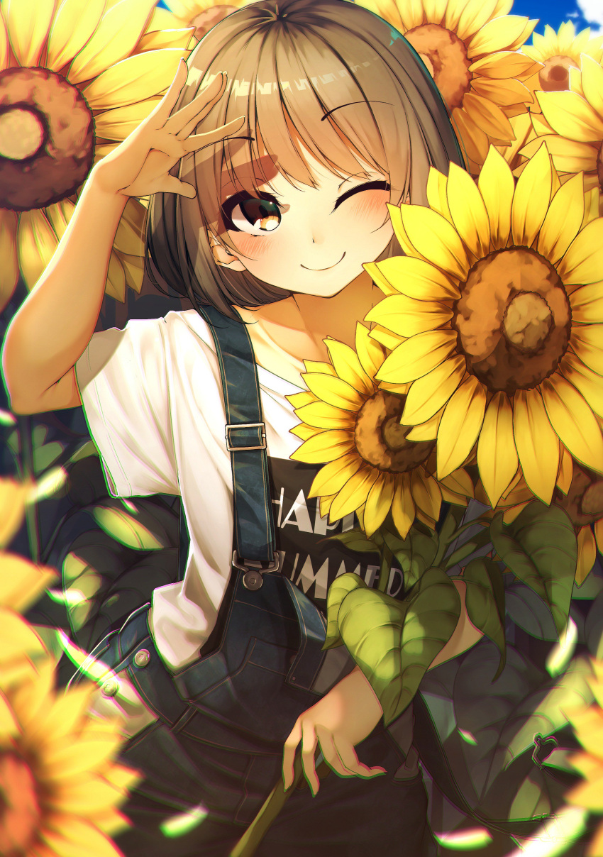 1girl ;) absurdres arm_up bangs blue_sky blurry blurry_foreground blush brown_eyes brown_hair closed_mouth clothes_writing clouds collarbone commentary_request day depth_of_field eyebrows_visible_through_hair field fingernails flower flower_field highres long_hair looking_at_viewer one_eye_closed original outdoors overalls rerrere shirt short_sleeves sky smile solo sunflower t-shirt white_shirt wide_sleeves yellow_flower