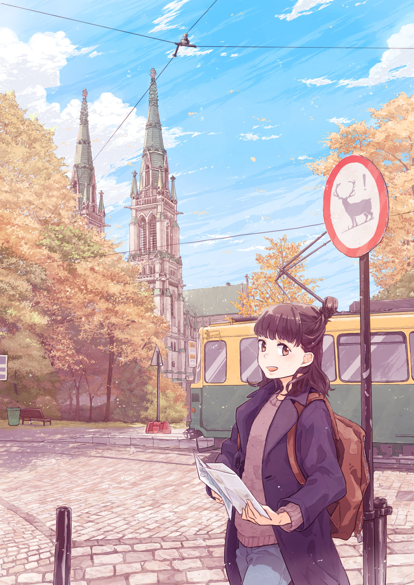 1girl :d absurdres autumn_leaves backpack bag bangs bench black_hair brown_backpack brown_eyes building cathedral commentary_request day denim hair_bun half_updo highres holding_map jeans kujyoo looking_at_viewer medium_hair navy_blue_jacket open_mouth original outdoors pants park_bench power_lines road road_sign sign smile solo streetcar sweater trash_can tree