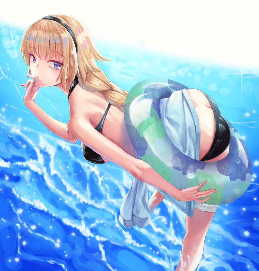 1girl ass bikini black_bikini black_hairband blonde_hair blue_hoodie braid breasts butt_crack fate/grand_order fate_(series) hairband hand_to_own_mouth highres hood hoodie hoodie_removed innertube jeanne_d'arc_(fate)_(all) jeanne_d'arc_(swimsuit_archer) large_breasts leaning_forward long_braid long_hair looking_at_viewer looking_to_the_side nekobell ocean partially_submerged single_braid solo swimsuit very_long_hair violet_eyes