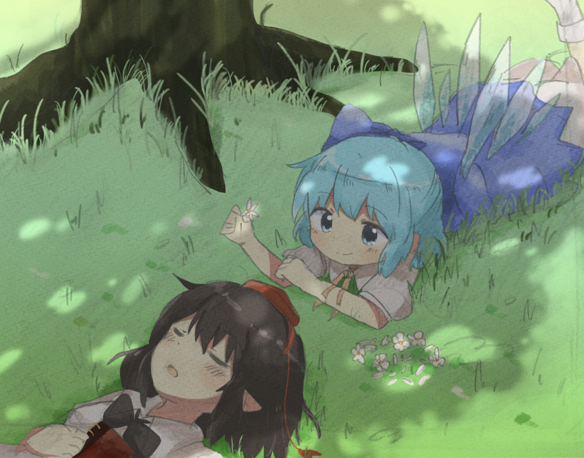 2girls :o blue_dress blue_eyes blue_hair blush bow brown_hair cirno closed_eyes commentary_request dappled_sunlight dress flower grass hair_bow hat highres ice ice_wings kototoki leg_up lying multiple_girls on_stomach outdoors petals pointy_ears shameimaru_aya short_hair short_sleeves sleeping smile sunlight texture tokin_hat touhou tree wings