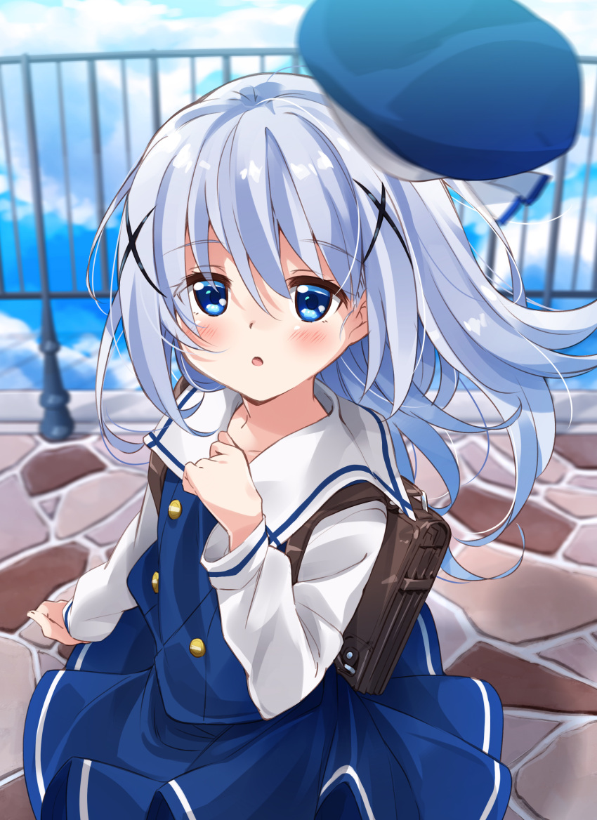 1girl :o absurdres backpack bag bangs beret blue_eyes blue_hair blue_hat blue_skirt blue_sky blue_vest blurry blurry_background blush clouds cloudy_sky collarbone commentary_request day depth_of_field eyebrows_visible_through_hair fingernails gochuumon_wa_usagi_desu_ka? hair_between_eyes hair_ornament hand_up hat hat_removed headwear_removed highres kafuu_chino kafuu_chino's_school_uniform long_hair long_sleeves looking_at_viewer looking_to_the_side mousou_(mousou_temporary) outdoors parted_lips railing sailor_collar school_uniform shirt skirt sky solo very_long_hair vest white_sailor_collar white_shirt x_hair_ornament