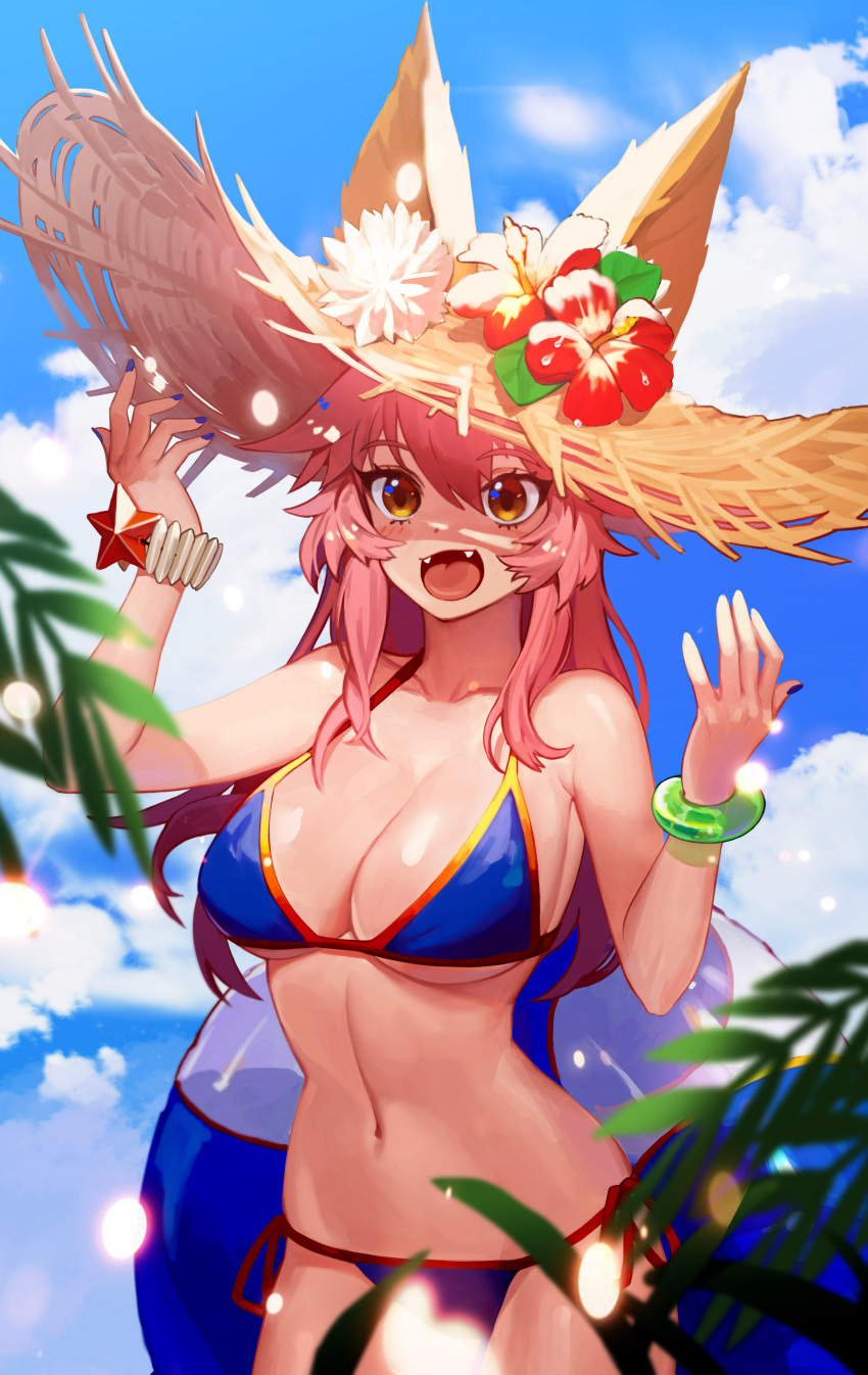 1girl absurdres animal_ear_fluff animal_ears bikini blue_bikini breasts cleavage collarbone day ears_through_headwear fangs fate/grand_order fate_(series) flower fox_ears fox_girl fox_tail groin hat hibiscus highres in innertube large_breasts looking_at_viewer nail nail_polish navel ocean open_mouth outdoors palm_tree pink_hair side-tie_bikini solo straw_hat swimsuit tail tamamo_(fate)_(all) tamamo_no_mae_(swimsuit_lancer)_(fate) tree yellow_eyes