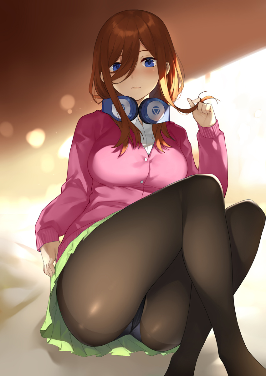1girl ass black_legwear blue_eyes breasts brown_hair closed_mouth collared_shirt expressionless eyebrows_visible_through_hair feet_out_of_frame go-toubun_no_hanayome green_skirt hair_between_eyes hair_twirling hand_up headphones headphones_around_neck highres knees_up legs_crossed long_hair looking_at_viewer medium_breasts nakano_miku panties panties_under_pantyhose pantyhose pink_sweater pleated_skirt see-through shirt sitting skirt sleeves_past_wrists solo sweater underwear white_shirt yykuaixian