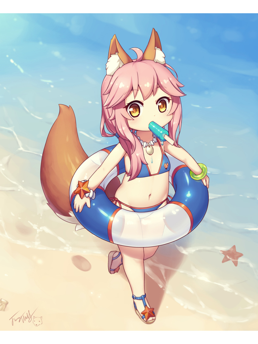 1girl animal_ear_fluff animal_ears bangs bare_shoulders beach bikini blue_bikini blush bracelet brown_footwear brown_hair eyebrows_visible_through_hair fate/grand_order fate_(series) flat_chest food food_in_mouth fox_ears fox_girl fox_tail highres holding holding_innertube innertube jewelry langbazi letterboxed long_hair looking_at_viewer mouth_hold navel necklace outdoors pink_hair popsicle sand sandals side-tie_bikini sidelocks signature solo standing standing_on_one_leg starfish sunset swimsuit tail tail_raised tamamo_(fate)_(all) tamamo_no_mae_(swimsuit_lancer)_(fate) water younger