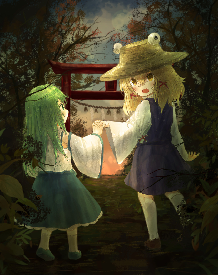 2girls absurdres arm_at_side arm_up blonde_hair blue_footwear blue_skirt blue_vest brown_footwear clouds commentary_request detached_sleeves ekaapetto from_behind full_body gradient_sky green_eyes green_hair hair_between_eyes hair_ribbon hand_holding hat highres interlocked_fingers kneehighs kochiya_sanae long_hair long_sleeves looking_at_another looking_at_viewer looking_back medium_hair moriya_suwako multiple_girls open_mouth outdoors ribbon rope shide shimenawa skirt sky standing torii touhou twilight vest white_legwear white_vest yellow_eyes younger