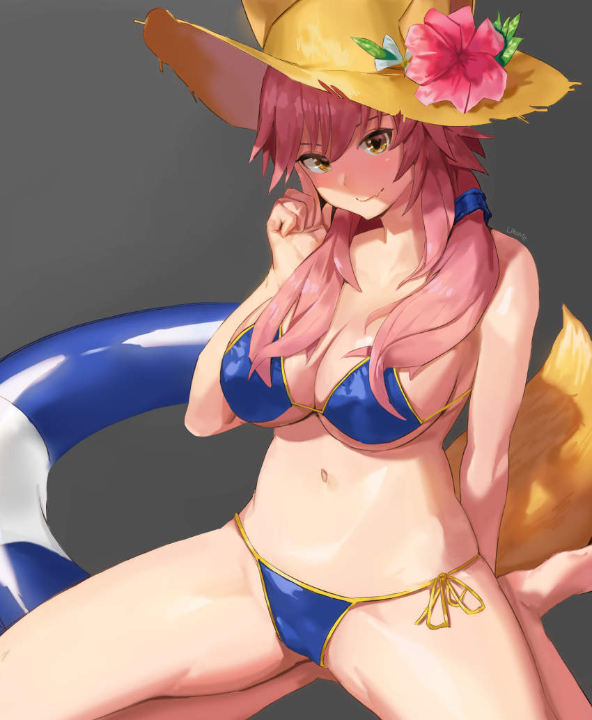 1girl absurdres animal_ears bangs bare_shoulders bikini blue_bikini blue_ribbon blush breasts cleavage closed_mouth collarbone ears_through_headwear fate/extra fate/grand_order fate_(series) flower fox_ears fox_tail grey_background hair_between_eyes hair_ribbon hat hat_flower highres innertube large_breasts long_hair looking_at_viewer low_twintails navel pink_hair ribbon side-tie_bikini sidelocks simple_background smile solo straw_hat sun_hat swimsuit tail tamamo_(fate)_(all) tamamo_no_mae_(swimsuit_lancer)_(fate) twintails uronte yellow_eyes