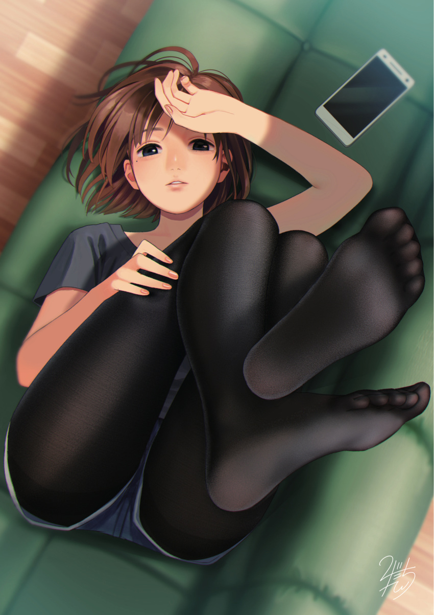 1girl black_legwear black_shirt blue_eyes blue_shorts brown_hair cellphone couch feet highres legs_up looking_at_viewer lying mole mole_under_eye nashigaya_koyomi no_shoes on_back on_couch original pantyhose parted_lips phone scan shirt short_hair short_shorts short_sleeves shorts signature smartphone solo teeth