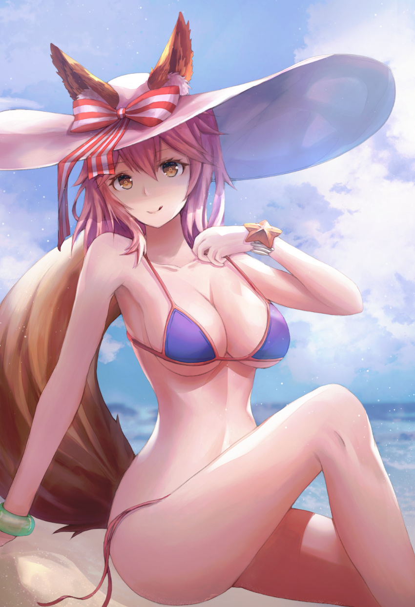 1girl animal_ear_fluff animal_ears beach bikini blue_bikini breasts cleavage ears_through_headwear fate/grand_order fate_(series) fox_ears fox_tail hat highres large_breasts looking_at_viewer necoring862 outdoors pink_hair side-tie_bikini sitting solo sun_hat swimsuit tail tamamo_(fate)_(all) tamamo_no_mae_(swimsuit_lancer)_(fate) tongue tongue_out yellow_eyes