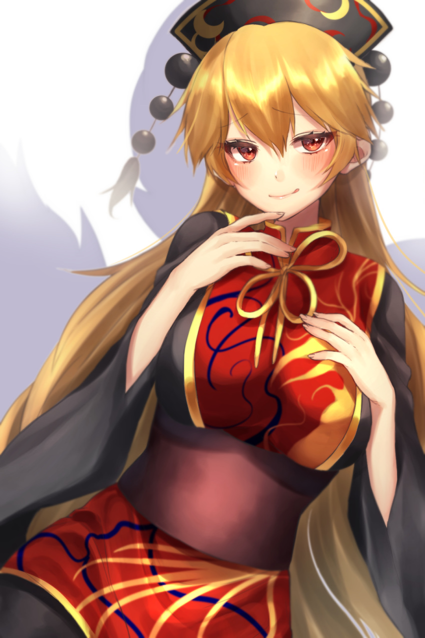 1girl :q aura bangs black_dress blonde_hair blush breasts commentary_request cowboy_shot dress eyebrows_visible_through_hair hair_between_eyes hand_on_own_chest hands_up headdress highres junko_(touhou) large_breasts long_hair long_sleeves looking_at_viewer neck_ribbon red_eyes ribbon sash simple_background smile solo tabard tassel tongue tongue_out touhou very_long_hair white_background wide_sleeves yayoimaka03 yellow_neckwear yellow_ribbon