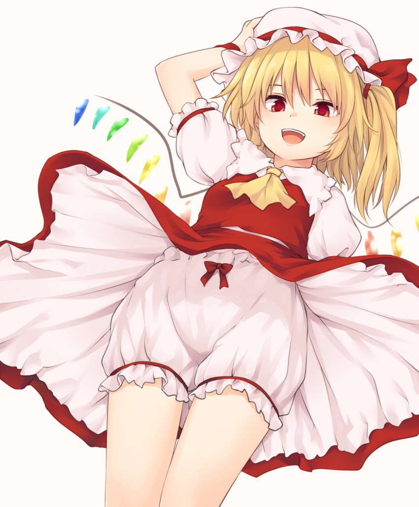 1girl :d arm_up ascot bangs blonde_hair bloomers bow breasts commentary_request cowboy_shot crystal dutch_angle eyebrows_visible_through_hair fangs flandre_scarlet frilled_shirt_collar frills from_below grey_background hair_between_eyes hair_tie hand_on_headwear hat hat_ribbon highres long_hair looking_at_viewer miyo_(ranthath) mob_cap one_side_up open_mouth petticoat puffy_short_sleeves puffy_sleeves red_bow red_eyes red_ribbon red_skirt red_vest ribbon shirt short_sleeves simple_background skirt skirt_set small_breasts smile solo standing thighs touhou underwear vest white_bloomers white_hat white_shirt wings wristband yellow_neckwear