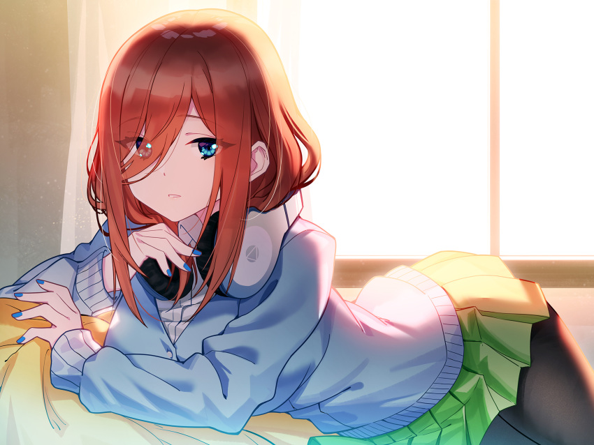 1girl backlighting black_legwear blue_cardigan blue_eyes blue_nails blush curtains cushion dust_particles eyebrows_visible_through_hair eyes_visible_through_hair fingernails go-toubun_no_hanayome green_skirt hair_over_one_eye headphones headphones_around_neck highres indoors long_hair long_sleeves looking_at_viewer lying midriff nail_polish nakano_miku on_side pantyhose parted_lips pleated_skirt skirt solo sunlight window zhanzheng_zi