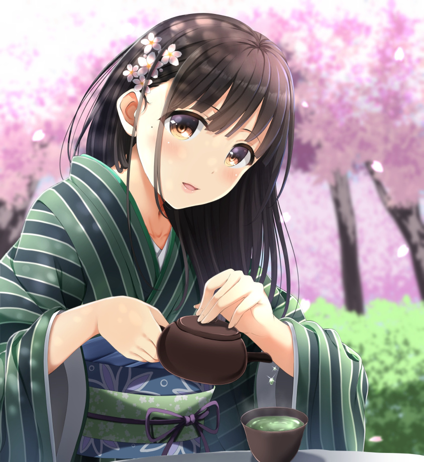 1girl bangs blurry blurry_background blush brown_eyes brown_hair cherry_blossoms commentary_request cup day depth_of_field eyebrows_visible_through_hair fingernails flower green_kimono green_tea hair_flower hair_ornament head_tilt highres holding japanese_clothes kimono long_hair long_sleeves mole mole_under_eye obi original outdoors parted_lips pink_flower sash solo striped tea tree vertical-striped_kimono vertical_stripes white_flower wide_sleeves yukimochi_kinako