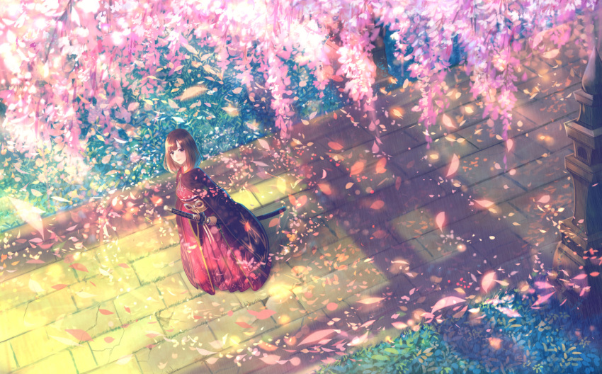 1girl bangs brown_eyes brown_hair closed_mouth commentary_request day fantasy from_above grass holding holding_sword holding_weapon japanese_clothes katana kimono long_hair looking_at_viewer looking_up obi original outdoors pavement petals plant red_kimono sakimori_(hououbds) sash sheath sheathed smile solo standing sunlight sword weapon wide_shot