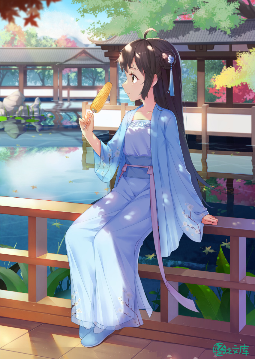 1girl absurdres ahoge architecture autumn_leaves blue_dress blue_footwear brown_eyes brown_hair corn dappled_sunlight day dress east_asian_architecture eating floral_print hair_bun hair_ornament highres lily_pad long_hair looking_away official_art outdoors pond reflection rock shadow sidelocks sitting sitting_on_railing solo sunlight taku_michi tree wide_sleeves