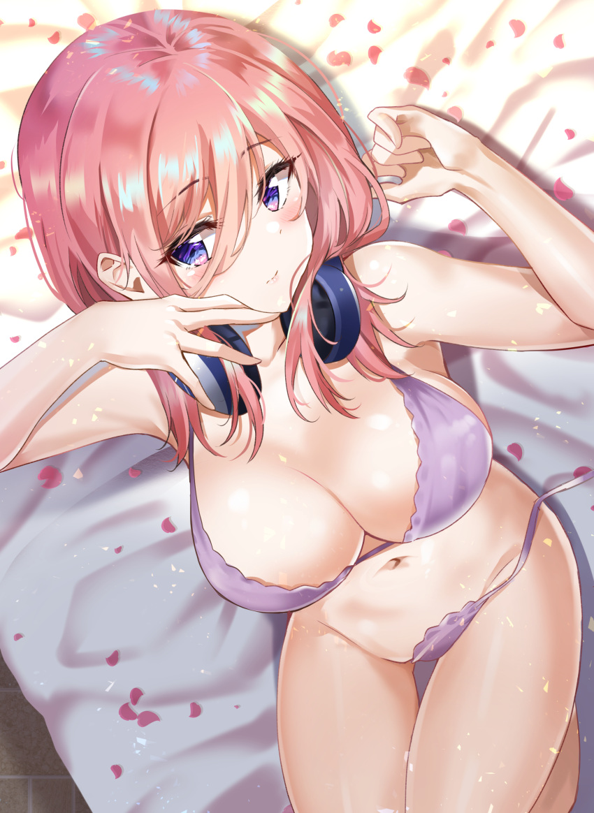 1girl absurdres bangs bare_shoulders bed_sheet blue_eyes blush bra breasts cleavage closed_mouth collarbone commentary eyebrows_visible_through_hair eyelashes from_above go-toubun_no_hanayome groin hair_between_eyes headphones headphones_around_neck highres knees_up large_breasts long_hair looking_at_viewer lying nakano_miku navel on_back on_bed panties petals pink_hair purple_bra purple_panties revision side-tie_panties sidelocks solo stomach sunhyun underwear underwear_only untied untied_panties