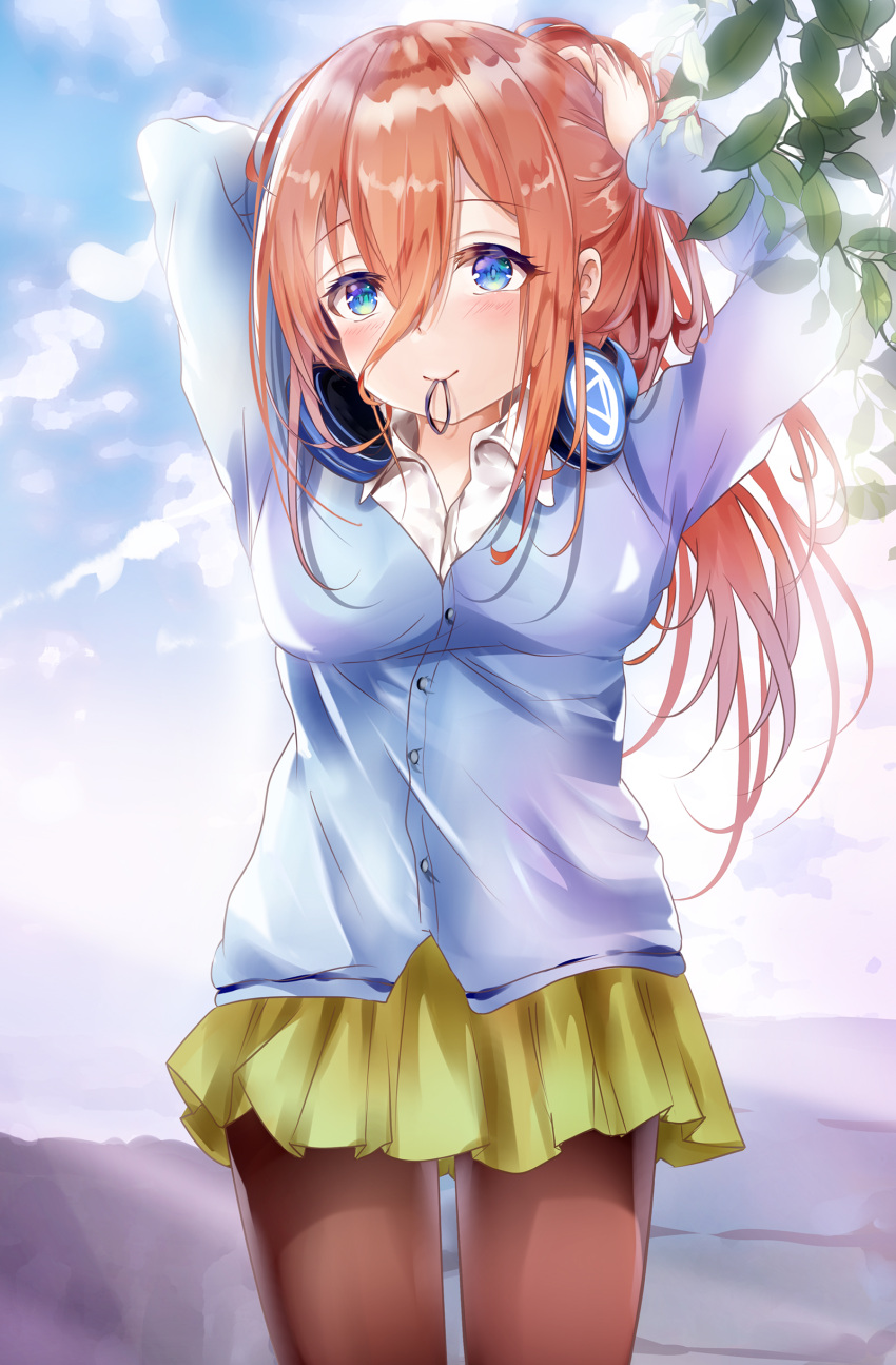 1girl absurdres arms_up bangs blue_cardigan blue_eyes blue_sky blush breasts brown_hair brown_legwear cardigan closed_mouth clouds collared_shirt commentary_request day eyebrows_visible_through_hair go-toubun_no_hanayome green_skirt hair_between_eyes hair_tie hair_tie_in_mouth head_tilt headphones headphones_around_neck highres long_hair long_sleeves looking_at_viewer medium_breasts mouth_hold mutang nakano_miku outdoors pantyhose pleated_skirt school_uniform shirt skirt sky smile solo tying_hair very_long_hair white_shirt