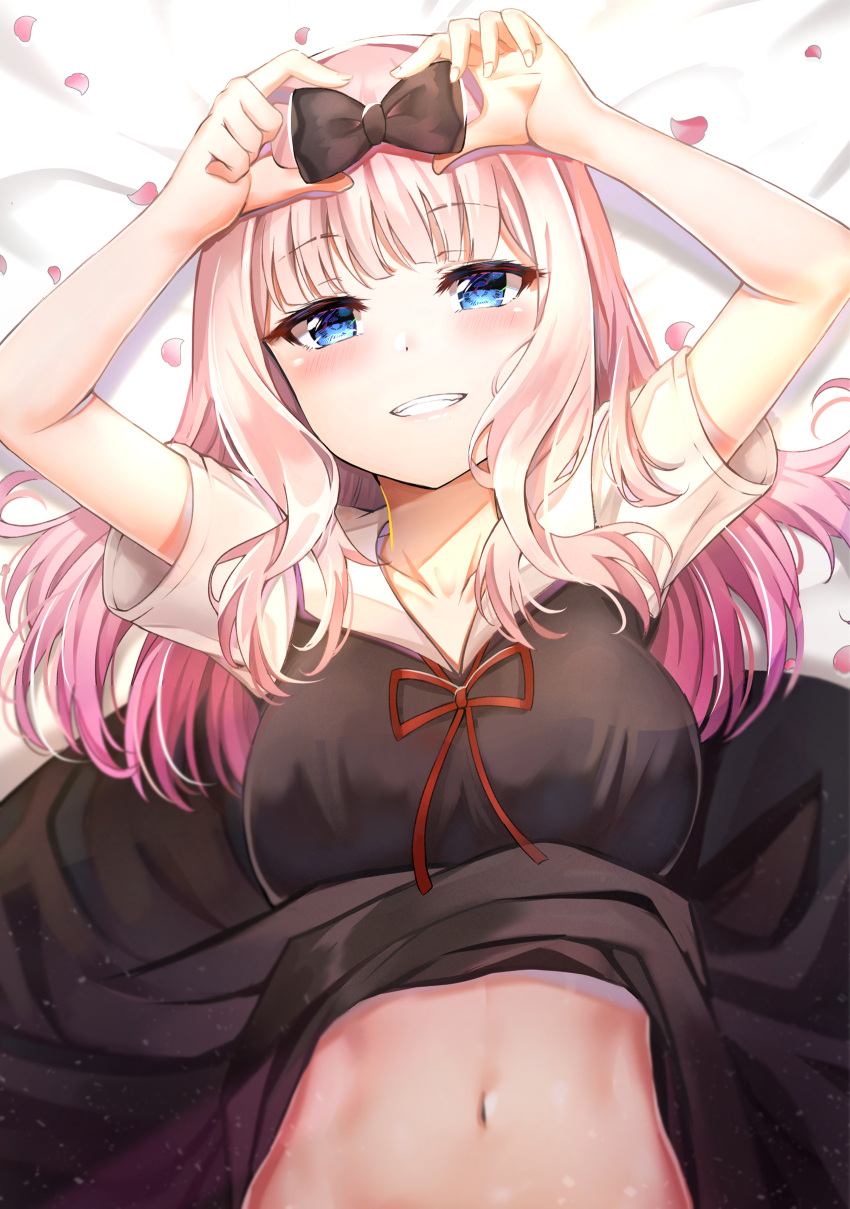 1girl absurdres arms_up bare_arms bed_sheet black_bow black_dress blue_eyes blurry blush bow breasts collarbone collared_dress commentary_request depth_of_field dress dress_lift fujiwara_chika grin hair_bow highres holding kaguya-sama_wa_kokurasetai_~tensai-tachi_no_renai_zunousen~ korean_commentary large_breasts light_particles long_hair looking_at_viewer lying navel on_back petals pink_hair red_neckwear short_sleeves sidelocks smile solo stomach sunhyun teeth upper_body