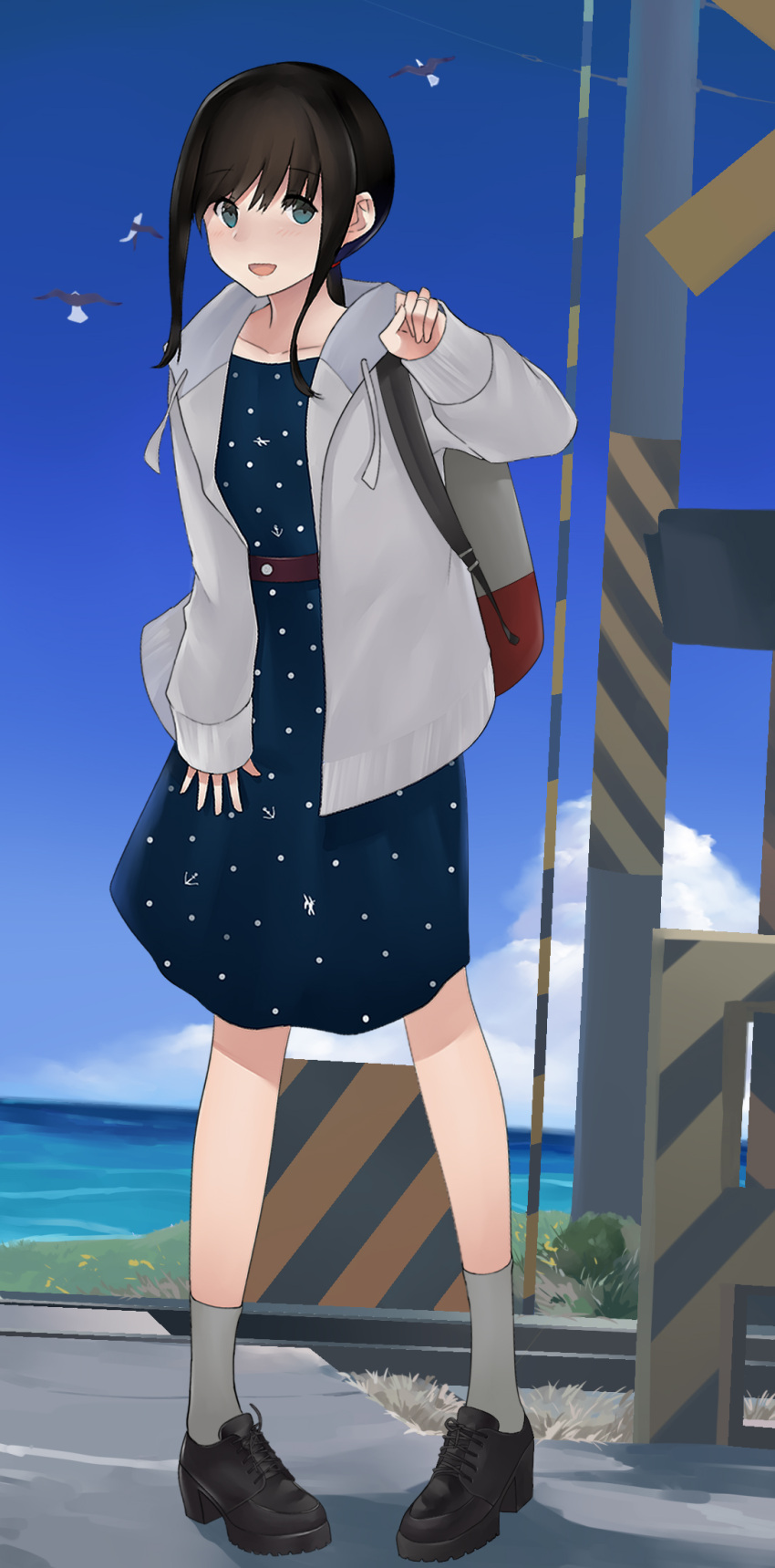 1girl alternate_costume backpack bag black_eyes black_footwear black_hair blue_dress blue_sky clouds day drawstring dress fubuki_(kantai_collection) grey_legwear highres hood hooded_jacket hoodie horizon jacket kantai_collection kuroinu9 loafers looking_at_viewer low_ponytail ocean open_mouth outdoors polka_dot polka_dot_dress ponytail railroad_crossing railroad_tracks shoes short_ponytail sidelocks sky smile socks solo white_jacket