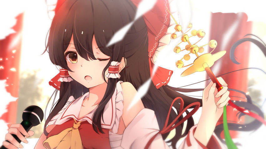 1girl absurdres ascot bare_shoulders bell black_hair blurry blurry_background bow breasts brown_eyes collarbone detached_sleeves frilled_bow frilled_shirt_collar frills hair_bow hair_tubes hakurei_reimu hand_up highres holding holding_microphone hunya jingle_bell long_hair long_sleeves looking_at_viewer medium_breasts microphone one_eye_closed open_mouth red_bow red_ribbon ribbon ribbon-trimmed_sleeves ribbon_trim sarashi shide sidelocks solo touhou upper_body wide_sleeves yellow_neckwear