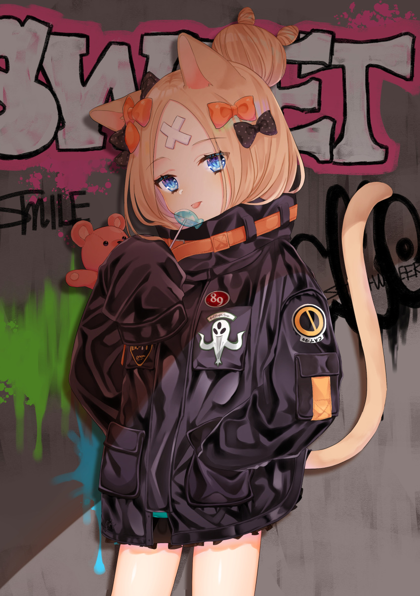 1girl abigail_williams_(fate/grand_order) animal_ears bangs black_bow black_jacket blonde_hair blue_eyes bow candy cat_ears cat_girl cat_tail closed_mouth commentary_request cowboy_shot crossed_bandaids etto_eat eyebrows_visible_through_hair fate/grand_order fate_(series) food graffiti hair_bow hair_bun hand_in_pocket head_tilt heroic_spirit_traveling_outfit highres holding holding_food holding_lollipop jacket kemonomimi_mode lollipop long_hair long_sleeves looking_at_viewer object_hug orange_bow parted_bangs polka_dot polka_dot_bow sleeves_past_fingers sleeves_past_wrists solo stuffed_animal stuffed_toy tail tail_raised teddy_bear tongue tongue_out