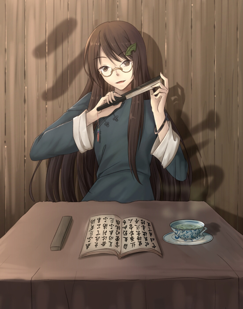 1girl against_wall alternate_costume arms_up bangs book bracelet brown-framed_eyewear brown_eyes brown_hair china_dress chinese_clothes chinese_commentary closed_fan commentary_request cup dress eyebrows_visible_through_hair fan folding_fan futatsuiwa_mamizou futatsuiwa_mamizou_(human) hair_ornament head_tilt highres holding holding_fan jewelry leaf leaf_hair_ornament long_hair long_sleeves looking_at_viewer minuo open_book parted_lips saucer semi-rimless_eyewear shadow sidelocks sitting solo swept_bangs table tablecloth teacup touhou under-rim_eyewear very_long_hair wooden_wall