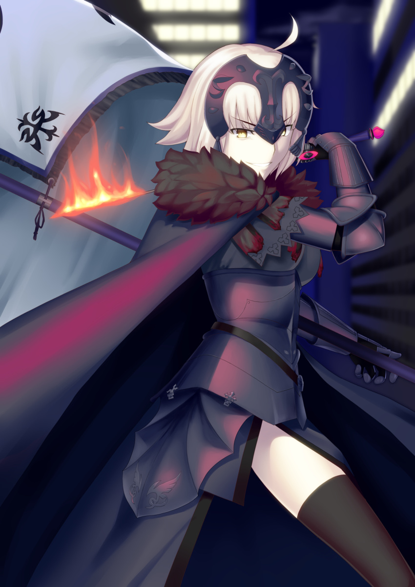 1girl ahoge armor armored_dress banner black_dress black_legwear blonde_hair blurry blurry_background cape daiz1213 dress fate/grand_order fate_(series) faulds fire fur_cape gauntlets headpiece highres holding holding_sword holding_weapon jeanne_d'arc_(alter)_(fate) jeanne_d'arc_(fate)_(all) looking_at_viewer short_hair solo standing sword thigh-highs v-shaped_eyebrows weapon yellow_eyes
