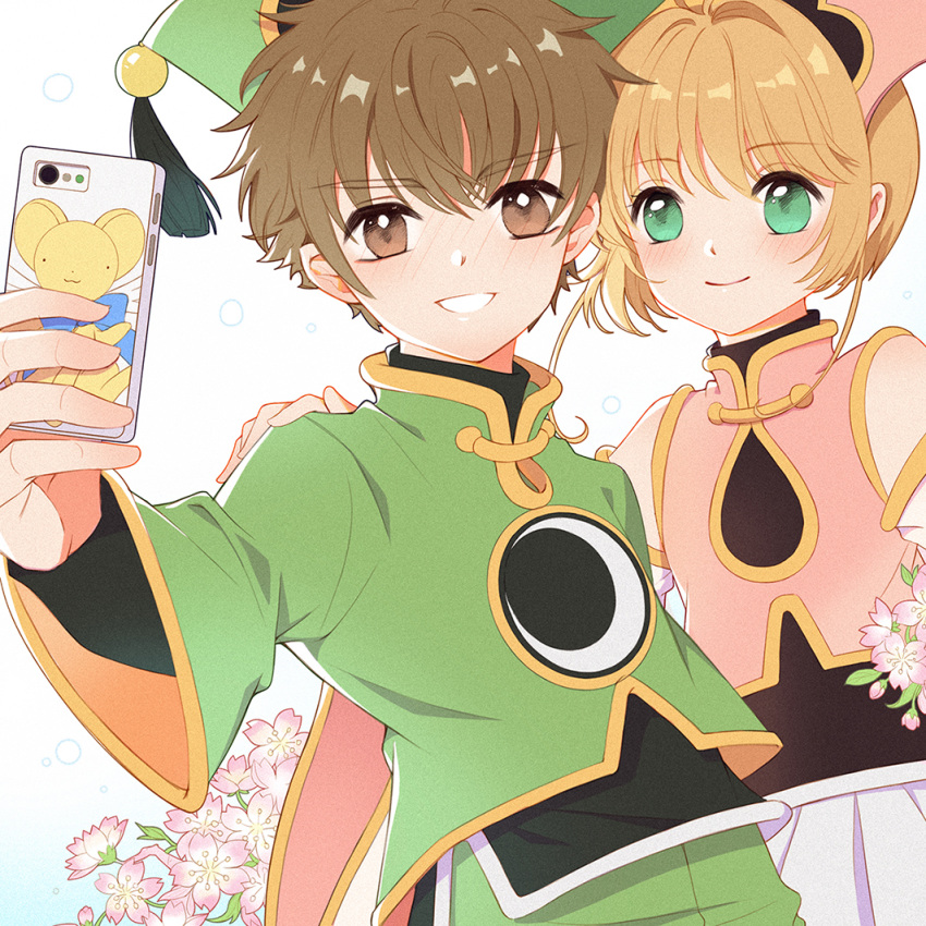 1boy 1girl bangs blush brown_eyes brown_hair card_captor_sakura cellphone cherry_blossoms chinese_clothes closed_mouth commentary_request duximeng eyebrows_visible_through_hair flower green_eyes green_headwear hand_on_another's_shoulder hat holding holding_cellphone holding_phone kero kinomoto_sakura li_xiaolang long_sleeves phone pink_flower pink_headwear short_hair smartphone smile upper_body wide_sleeves