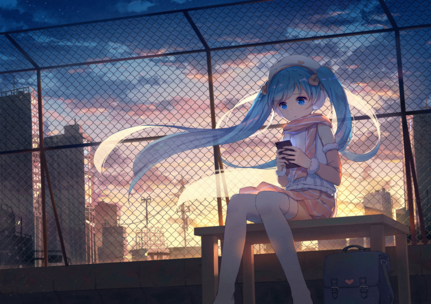 1girl bench blue_eyes blue_hair cellphone chain-link_fence city clouds detached_sleeves earmuffs fence floating_hair hat hatsune_miku highres long_hair phone scarf scenery sitting skirt sky smartphone solo sunset thigh-highs twintails very_long_hair vocaloid white_legwear yue_yue