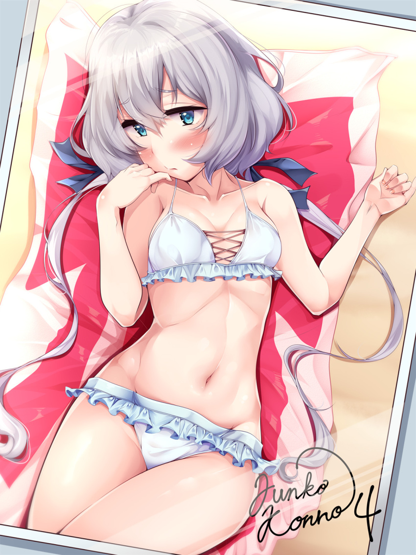 1girl beach_towel bikini blue_bikini blue_eyes blush breasts character_name collarbone frilled_bikini frills hair_between_eyes highres konno_junko long_hair low_twintails lying navel nksk on_back photo_(object) sand silver_hair small_breasts solo swimsuit towel twintails zombie_land_saga