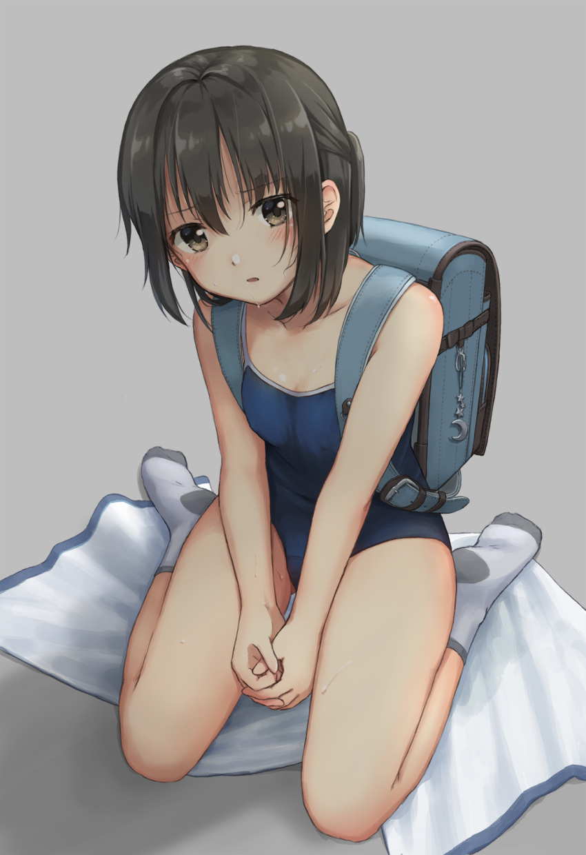 1girl backpack bag bag_charm bangs bare_arms bare_shoulders between_legs black_hair blue_swimsuit blush breasts brown_eyes charm_(object) cleavage collarbone commentary_request crescent drooling eyebrows_visible_through_hair full_body grey_background grey_legwear hand_between_legs highres hirose_yuki looking_at_viewer original own_hands_together randoseru saliva school_swimsuit short_hair short_ponytail simple_background sitting small_breasts socks solo star sweat swimsuit towel wariza