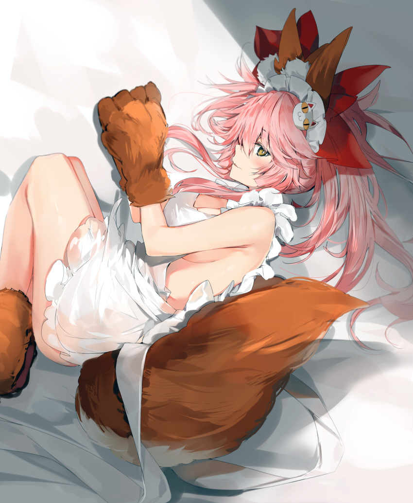1girl absurdres animal_ear_fluff animal_ears apron ass bangs bare_shoulders bed_sheet blush bow breasts brown_eyes brown_gloves cat_hair_ornament cat_paws cleavage eyebrows_visible_through_hair fang fate/extra fate/grand_order fate_(series) fox_ears fox_girl fox_tail gloves hair_between_eyes hair_bow hair_ornament highres large_breasts long_hair looking_at_viewer lying maid_apron maid_headdress naked_apron on_side parted_lips paw_gloves paw_shoes paws pink_hair ponytail profile red_bow shoes sidelocks silver_(chenwen) solo tail tamamo_(fate)_(all) tamamo_cat_(fate) white_apron